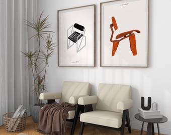 May include: Two framed illustrations of chairs, one in black and white and one in orange, hanging on a white wall above two white armchairs with black legs. A small black side table with a book and a letter 'U' on top sits in the corner.