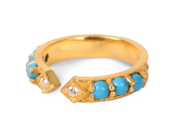 May include: A gold-colored ring with a split design, featuring turquoise beads and small, clear gemstones. The ring has a textured band and a unique, open-ended style, showcasing a blend of classic and modern elements.