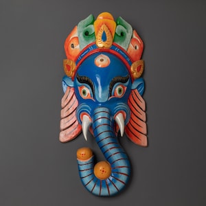 Hand Carved Ganesha Wall Hanging | Blue Elephant Head Mask with Bold Colors and Tusks | Hindu Decor for Meditation Room or Sacred Home Space