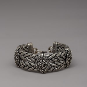Handcrafted Braided White Metal Bracelet | Intricate Buddhist Design | Artisan Metalwork | White Metal Bracelet with Cultural Significance |