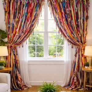 Puede incluir: Cortinas coloridas de estilo bohemio con tiras verticales de tela en varios colores, incluyendo rojo, amarillo, azul y morado. Las cortinas est&aacute;n atadas con cuerdas y tienen borlas. La ventana est&aacute; enmarcada en blanco.