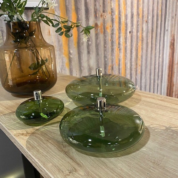 Modern glass oil lamp, transparent green color, living room decoration, cozy atmosphere, candle