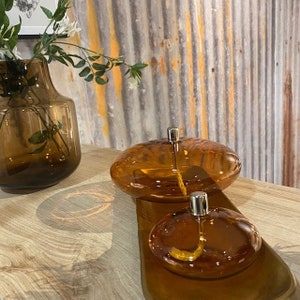 Modern glass oil lamp, transparent amber color, living room decoration, cozy atmosphere