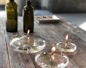 Modern glass oil lamp, transparent glass, living room decoration, cozy atmosphere, candle