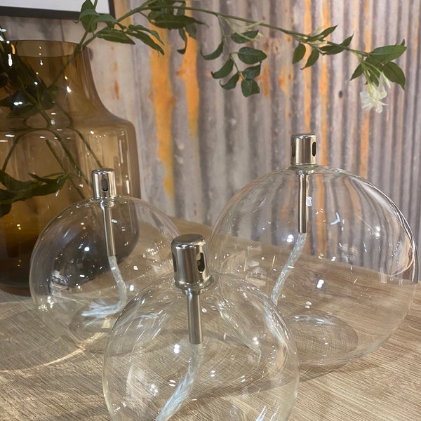 Modern glass oil lamp, transparent sphere, living room decoration, cozy atmosphere