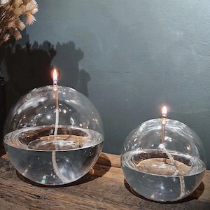 Modern glass oil lamp, transparent sphere, living room decoration, cozy atmosphere