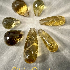 Seven natural Citrines in the shape of a briolè drop and an engraved drop. All drilled. 100% natural.