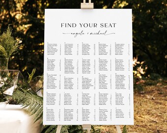May include: White wedding seating chart on an easel with the text "Find Your Seat" and "Angela + Michael" in cursive. The chart lists guest names in alphabetical order by last name.
