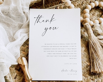 May include: A white thank you card with black calligraphy that reads "thank you". The card has a message thanking guests for attending a wedding and includes the couple's names and wedding date: "Amelia & Kenway 25.08.20XX".