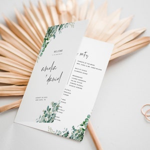 May include: A wedding order of service with a green watercolour floral design. The order of service includes the names Amelia and Daniel, the wedding date, and the names of the wedding party.