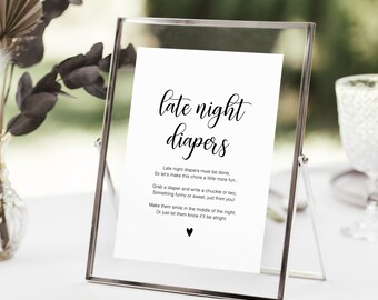 May include: A white sign with black text in a silver frame. The sign reads "late night diapers" and includes a poem about making diaper changes more fun.