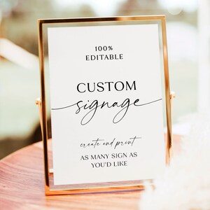 May include: A white sign with black text in a gold frame. The sign says "100% Editable Custom Signage create and print as many sign as you'd like".