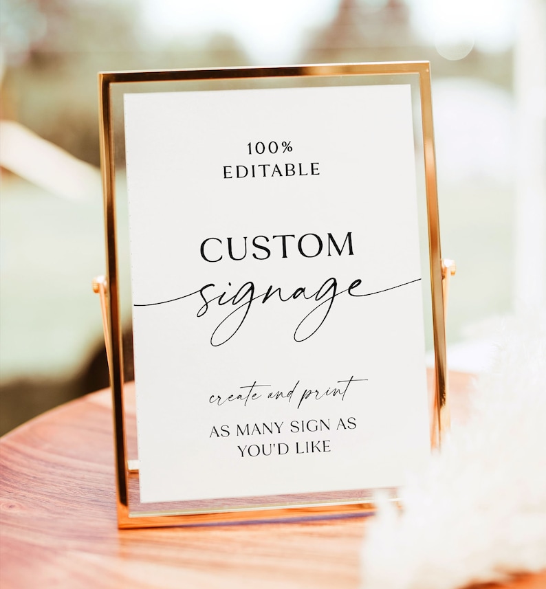 May include: A white sign with black text in a gold frame. The sign says "100% Editable Custom Signage create and print as many sign as you'd like".