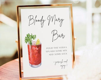 May include: A sign with a gold frame that says "Bloody Mary Bar" with a watercolor illustration of a Bloody Mary cocktail. The text below the illustration says "Pour the vodka, splash some mix, add some kick, garnish and enjoy!"