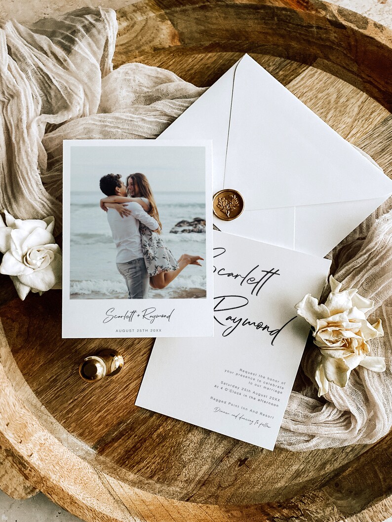 May include: A wedding invitation featuring a photograph of a couple on a beach. The invitation is white with black text and reads "Scarlett & Raymond" and "August 25th 20XX". The invitation also includes the text "Request the honour of your presence to celebrate our marriage" and "Saturday 25th August 20XX at 4 O'Clock in the afternoon" and "Ragged Point Inn And Resort".