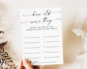 May include: A printable game card with the text "how old were they" and instructions to "Guess the age of the parents-to-be in each photo". The card has 10 numbered lines for players to write their guesses.