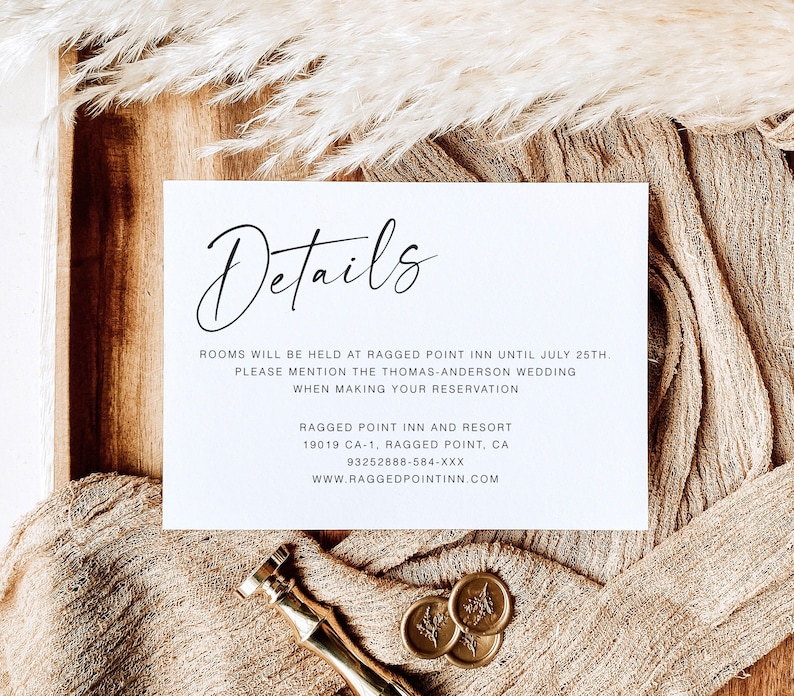 May include: A white card with the word "Details" written in black cursive script. The card provides information about a hotel, including the name, address, and phone number. The text reads: "Rooms will be held at Ragged Point Inn until July 25th. Please mention the Thomas-Anderson wedding when making your reservation. Ragged Point Inn and Resort 19019 CA-1, Ragged Point, CA 93252888-584-XXX www.raggedpointinn.com"