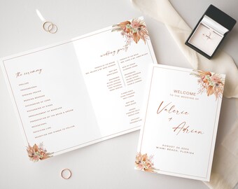 May include: Wedding ceremony program with a floral design and the text "the ceremony" and a list of events. A separate card with a floral design and the text "Welcome to the wedding of Valerie + Adrien" and the date and location of the wedding.