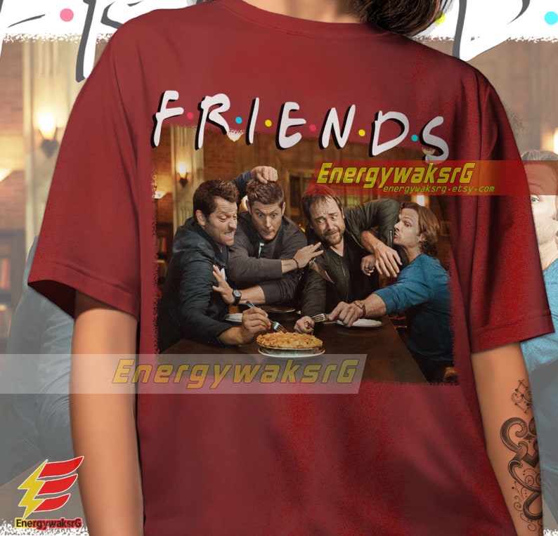 May include: Red t-shirt with a graphic print of four men sitting at a table with a pie. The text "FRIENDS" is above the image.