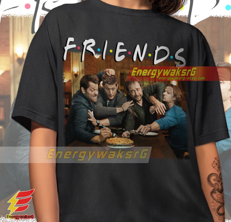 May include: Black t-shirt with a graphic of four men sitting at a table with a pie. The text "FRIENDS" is above the graphic.