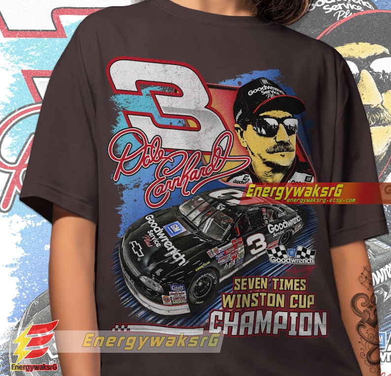 Pu&ograve; includere: Una maglietta marrone scuro con una grafica in stile vintage del pilota di auto da corsa Dale Earnhardt Jr. La grafica presenta un'auto da corsa nera con il numero 3, un ritratto di Earnhardt Jr. e il testo "Goodwrench" e "Seven Times Winston Cup Champion".
