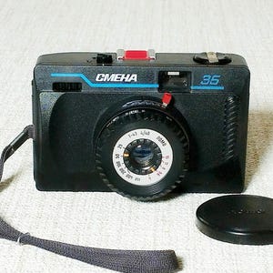 Film camera SMENA-35 — produced in the USSR by the LOMO association since 1990. The camera is in good condition, ready for use.