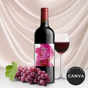 May include: A wine bottle label with a pink watercolor design and gold glitter. The label says "Jane's 30th birthday 08.09.XX".