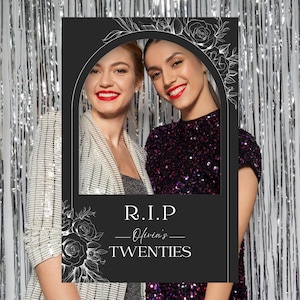 May include: Black and white photo booth prop with a floral design and the text "R.I.P. Olivia's TWENTIES".