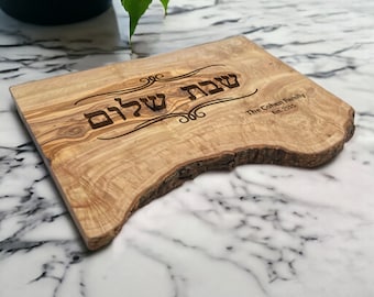 Può includere: Un tagliere di legno con un bordo naturale e un'iscrizione in ebraico che recita "Shabbat Shalom". Il tagliere è personalizzato con "The Cohen Family Est. 2015".