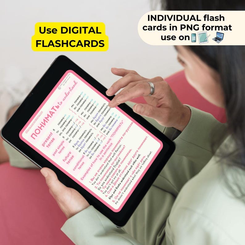 May include: A digital flashcard on a tablet screen with the Russian word "ПОНИМАТЬ" (to understand) and examples of how to use the verb in a sentence. The flashcard is pink and white with blue and green text.