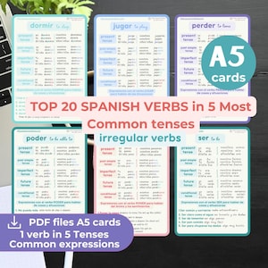 May include: A collection of A5 flashcards for learning Spanish verbs. The cards are white with blue, green, and purple accents. Each card features a different verb, with conjugations in five tenses. The text "TOP 20 SPANISH VERBS" is displayed.