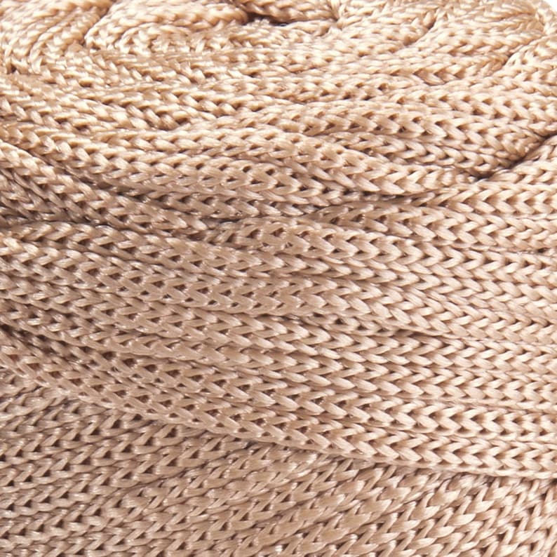 May include: A close-up of a beige braided rope, showing the intricate woven pattern.