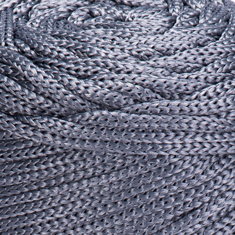 May include: Close-up of a coiled gray rope with a braided texture.