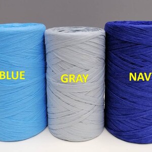 May include: Three spools of paper cord, one blue, one gray, and one navy blue. The spools are labeled "BLUE", "GRAY", and "NAVY".