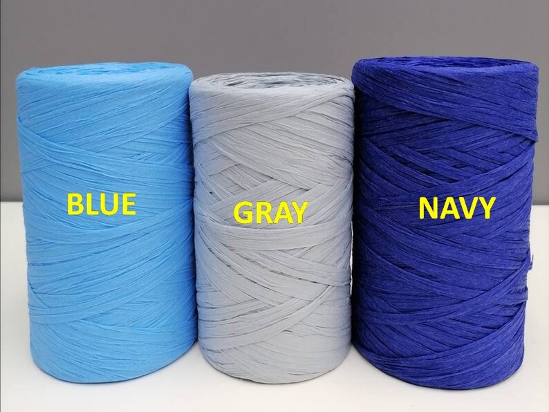 May include: Three spools of paper cord, one blue, one gray, and one navy blue. The spools are labeled "BLUE", "GRAY", and "NAVY".
