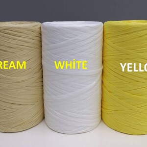 May include: Three spools of paper cord, one cream, one white, and one yellow. The spools are labeled "CREAM", "WHITE", and "YELLOW".