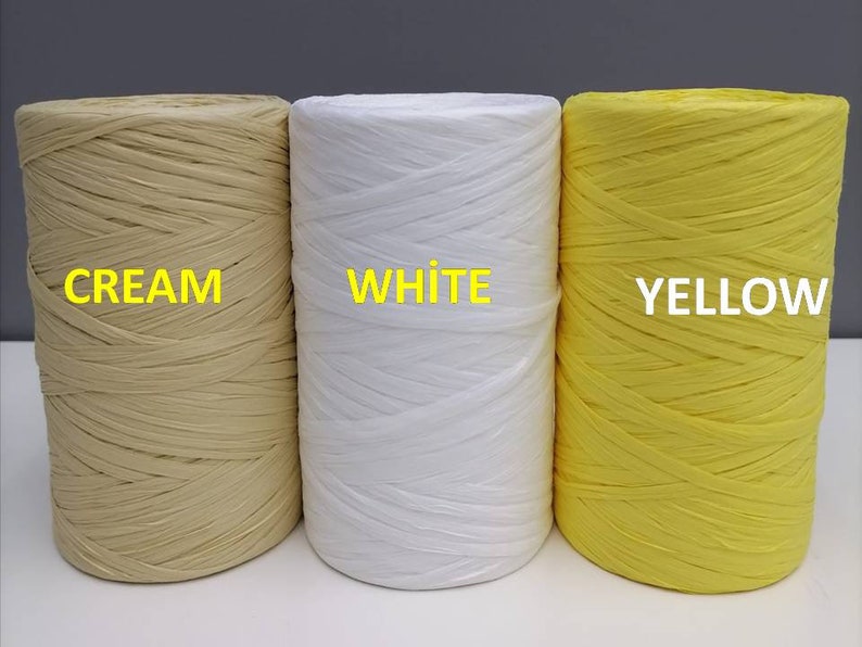 May include: Three spools of paper cord, one cream, one white, and one yellow. The spools are labeled "CREAM", "WHITE", and "YELLOW".