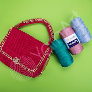 May include: A red crocheted handbag with a gold chain strap and a gold clasp. Three balls of yarn in pink, blue, and teal are next to the bag. The yarn is labeled "YarnArt Macrame XL."