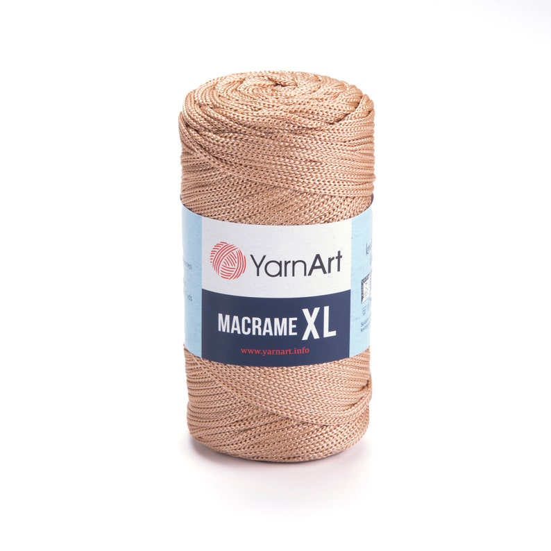 May include: A spool of beige macrame cord, labeled "YarnArt Macrame XL" with the website "www.yarnart.info" printed on the label.
