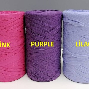 May include: Three spools of curling ribbon in pink, purple, and lilac. The spools are labeled "pink", "purple", and "lilac".