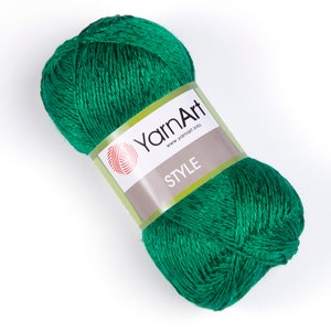 Pode incluir: Uma bola de fio verde com um r&oacute;tulo que diz "YarnArt www.yarnart.info STYLE".