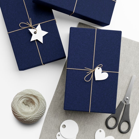 Gift wrapping presents on dark blue table. Stock Photo by ©amarosy 91746514