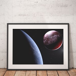 May include: A framed print of a space scene with two planets. The larger planet is red with white clouds and the smaller planet is blue with a dark side. The background is a dark blue with stars.
