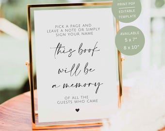 May include: A white rectangular sign in a thin gold frame with black text that reads: PICK A PAGE AND LEAVE A NOTE OR SIMPLY SIGN YOUR NAME, this book will be a memory, OF ALL THE GUESTS WHO CAME, with a small black heart icon at the bottom.