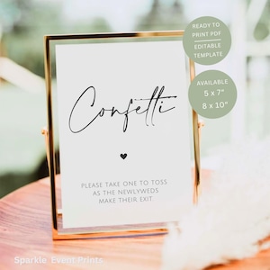 May include: A gold-framed sign with the word "Confetti" in elegant script, a heart, and the text "Please take one to toss as the newlyweds make their exit." The sign is available in 12.7 x 17.8 cm and 20.3 x 25.4 cm sizes.