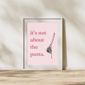May include: A pink poster with the text "it's not about the pasta." in a pink font. A black and white illustration of a fork with spaghetti on it is to the right of the text.