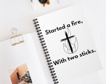 Started a fire with two sticks. Spiral Notebook - Ruled Line. Black print.