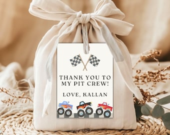 May include: A beige gift bag tied with a cream-colored ribbon, with a tag that reads "THANK YOU TO MY PIT CREW! LOVE, KALLAN." The tag features two checkered flags and illustrations of three monster trucks in blue, black, and red.