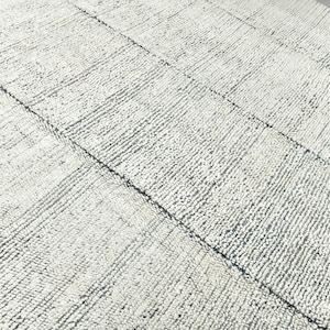 May include: A white and gray textured rug with a woven pattern. The rug has a subtle blue hue.