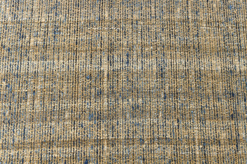 Handwoven area rug featuring geometric color blocks in rich navy blue, warm golden yellow, olive green and natural beige tones. This modern Turkish kilim style rug has a textured flat weave with white fringe edges, perfect for bohemian or Scandinavian interiors. Natural fiber construction creates an eco-friendly floor covering.